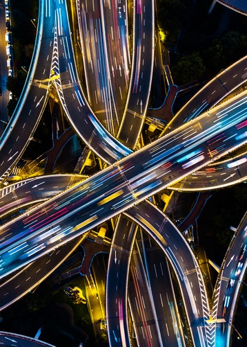 An overhead view of a busy highway system at night taken with long exposure